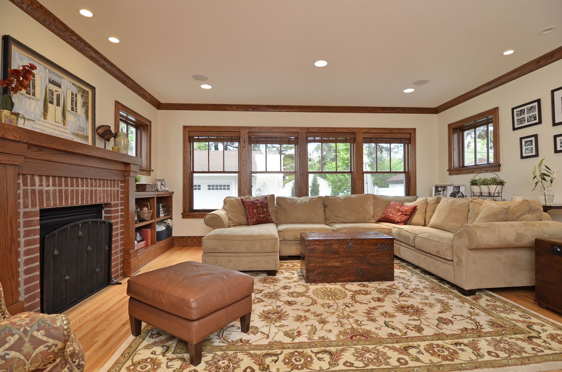 Living room with original brick fireplace, built-ins, and a band of craftsman windows
