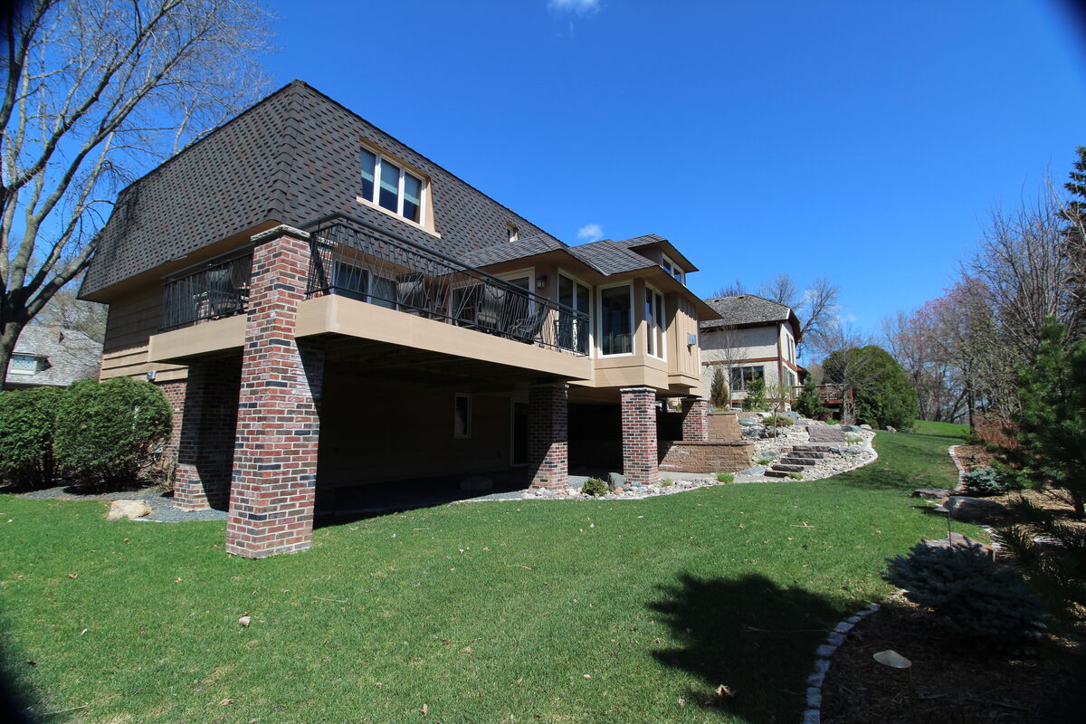 Twin Cities home addition with deck integration and restrained exterior detailing