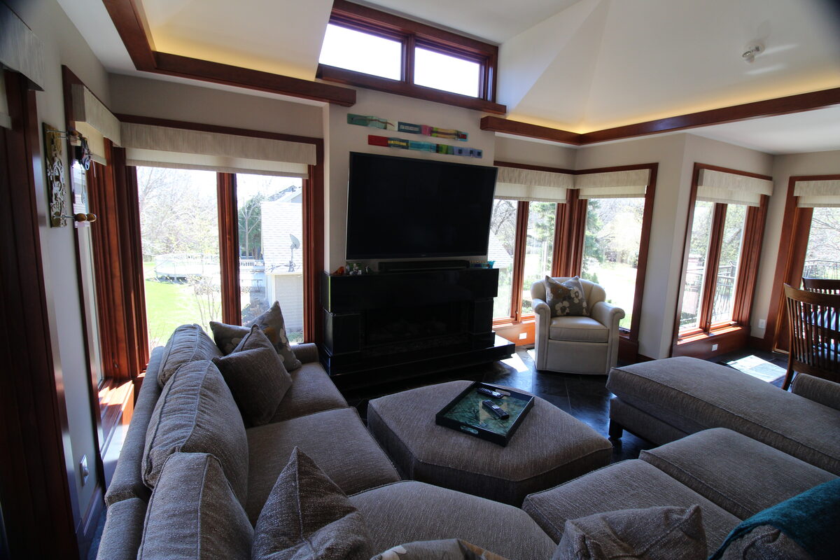 Family room addition with cathedral ceiling, transom windows, and a sectional sofa