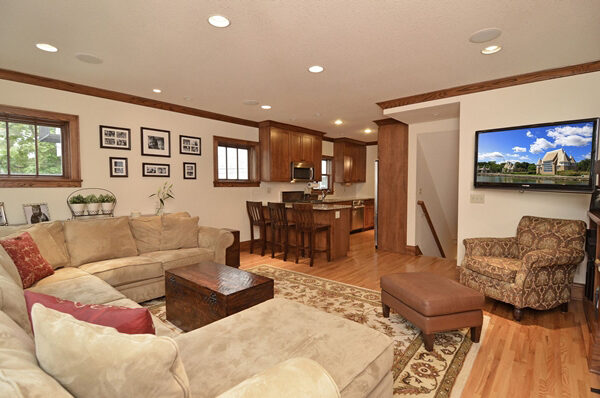 Family room looking into the kitchen with warm wood cabinetry visible beyond