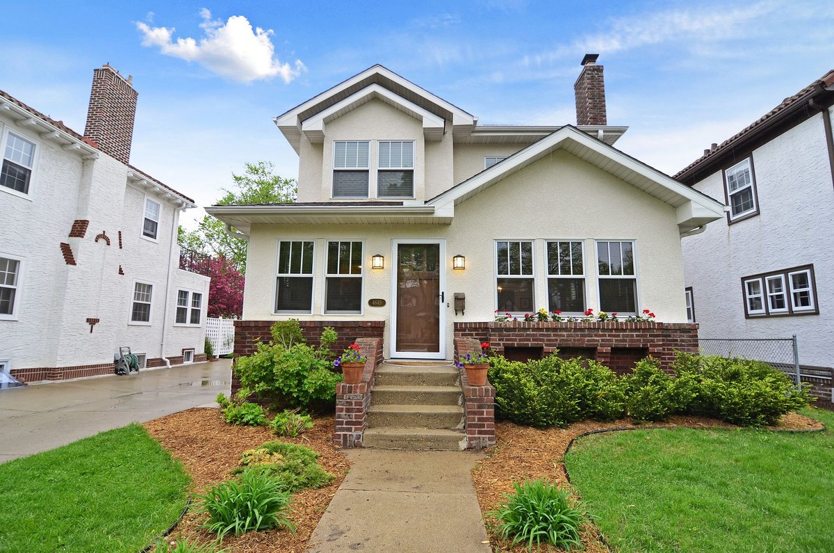 Traditional home with a full upper story above an enclosed front porch.