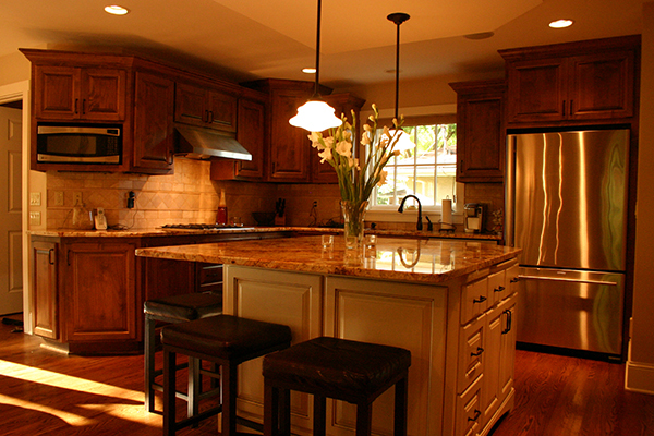 Kitchen with cherry cabinets, a painted island, granite counters, and stainless appliances