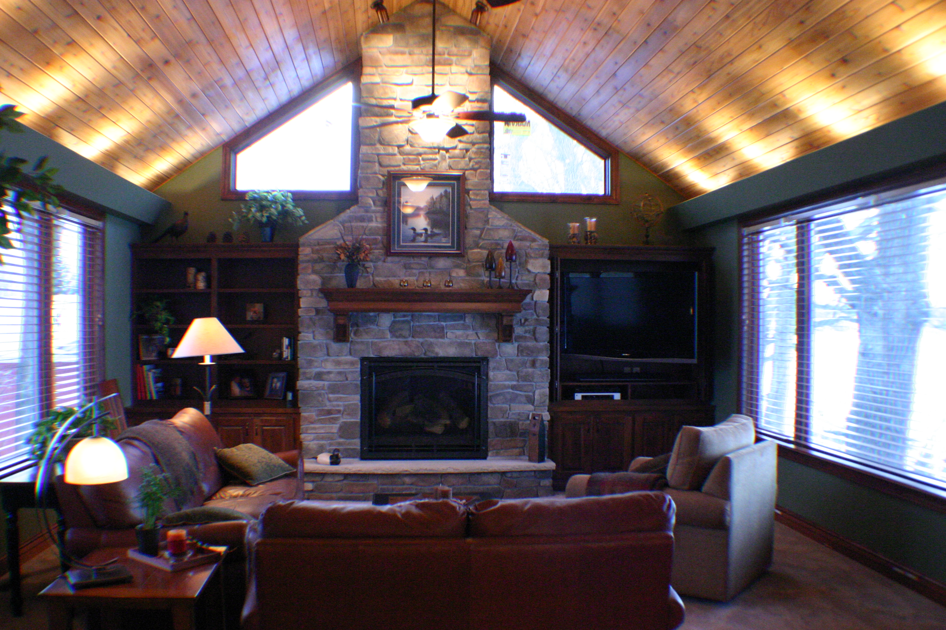 Vaulted great room with tongue-and-groove ceiling and a full-height stone fireplace
